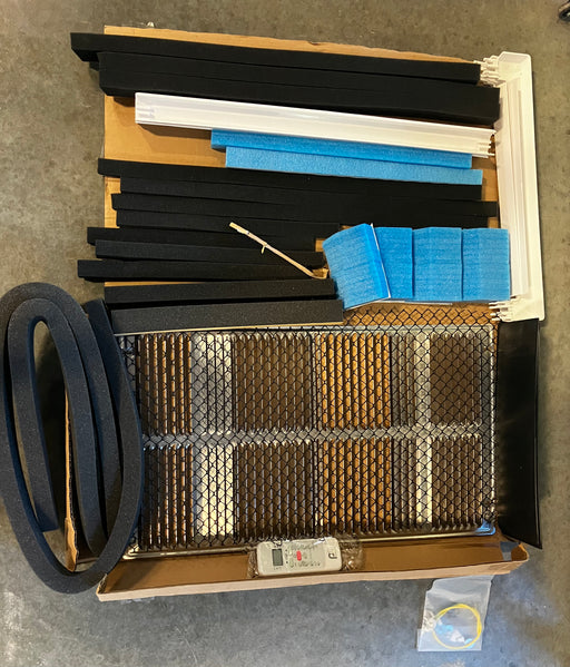 Assorted HVAC filters and parts on a cardboard box